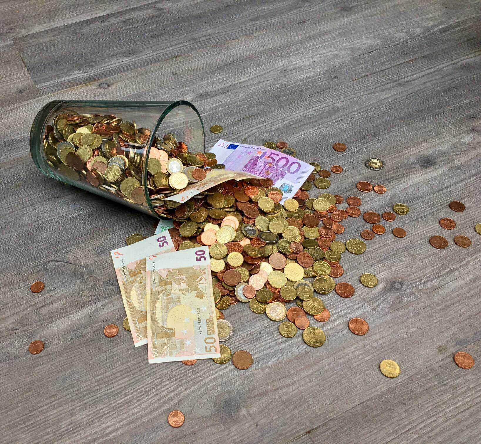 A jar of coins in foreign currencies